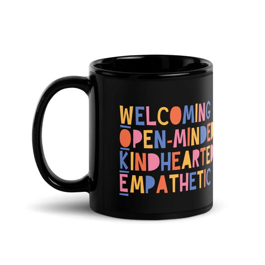 Playful WOKE colorful graphic that says "Welcoming Open-Minded Kindhearted Empathetic" on a black glossy ceramic coffee mug, Rebel Girl Rampage