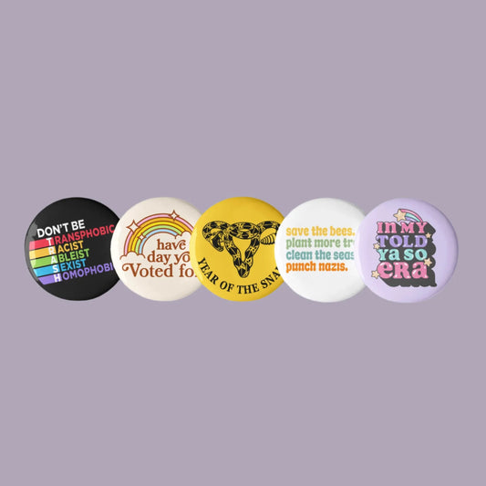 Progressive Pinback Buttons Set of Five Don’t Be Trash, Have The Day You Voted For, Year of the Snake Uterus, Punch Nazis, Rebel Girl Rampage