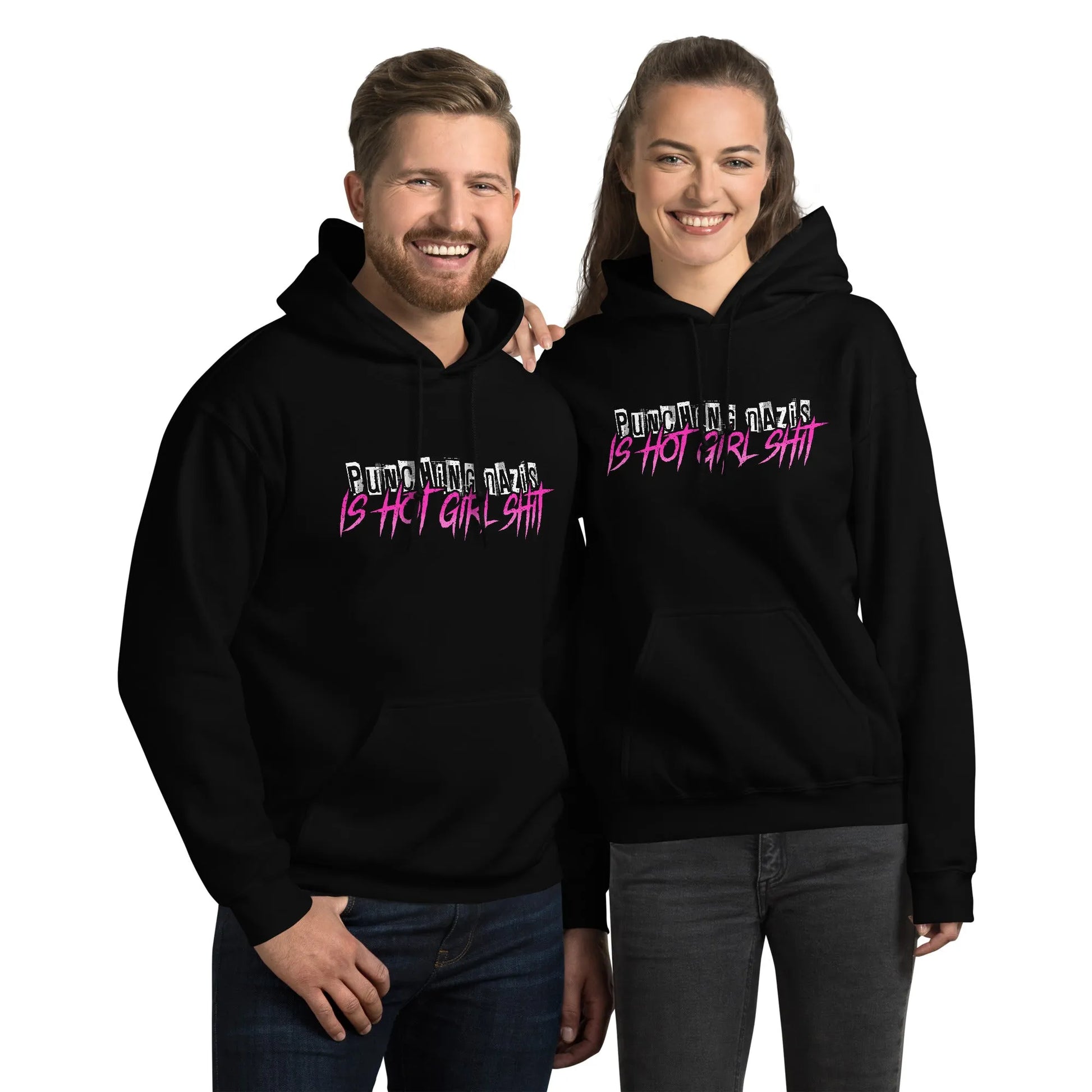 Hot girl Ish unisex hoodie, a smiling couple wearing black hoodie swith an 80s style graphic saying “punching Nazis is hot girl shit” Feminist antifa art, Rebel Girl Rampage