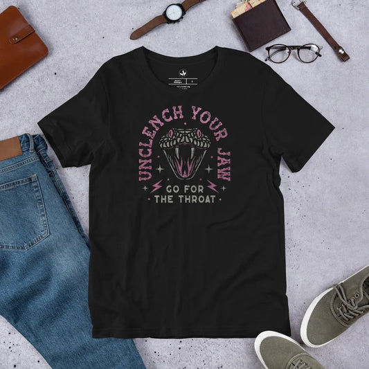 Pink and white snake graphic with the words, "Unclench Your Jaw Go For the Throat" on a black unisex t shirt, make a statement and be empowered to take on the powers that be, Rebel Girl Rampage