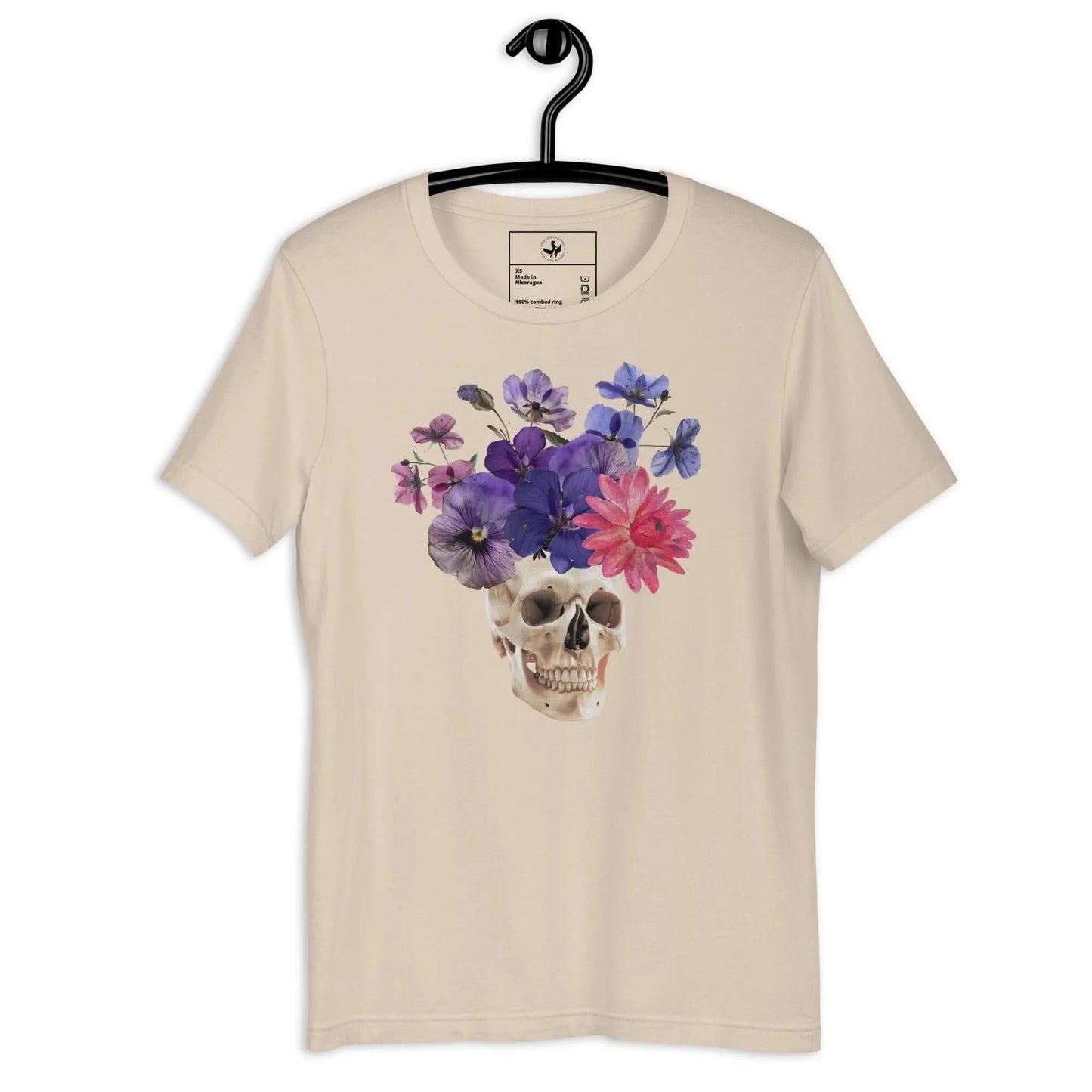Skull graphic with beautiful pink and purple flowers on a beige unisex t shirt, macabre, beautiful, nature, witchy, floral, spooky season, Rebel Girl Rampage
