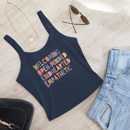 WOKE acronym playful colorful graphic that says "Welcoming Open-Minded Kindhearted Empathetic" on a navy crop tank top, Rebel Girl Rampage