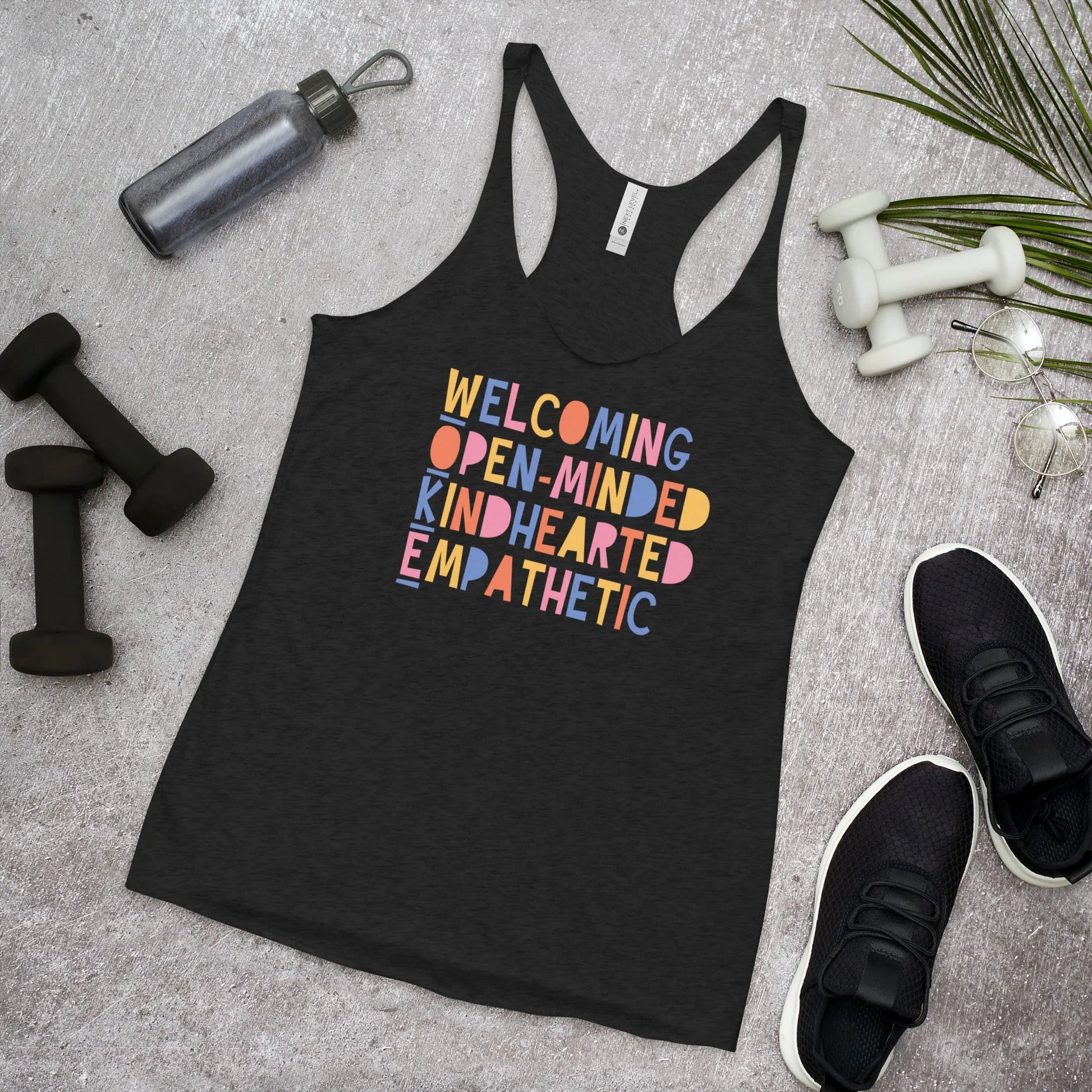 WOKE acronym playful colorful graphic that says "Welcoming Open-Minded Kindhearted Empathetic" on a black racerback tank top,  Rebel Girl Rampage