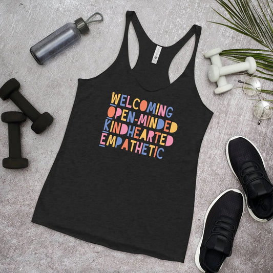 WOKE acronym playful colorful graphic that says "Welcoming Open-Minded Kindhearted Empathetic" on a black racerback tank top, Rebel Girl Rampage