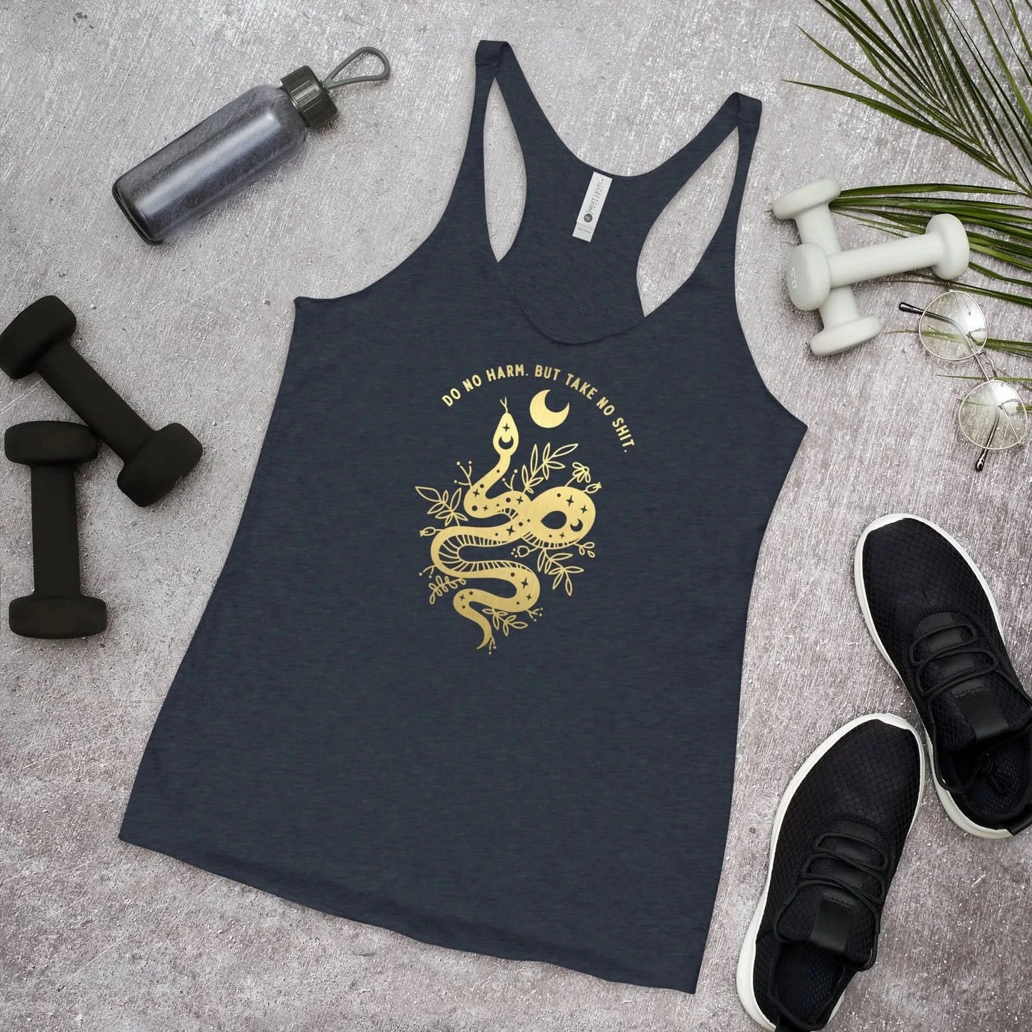 Golden witchy tattoo style snake with foliage and a moon and words that say, "Do no harm. But take no shit." on a navy racerback tank top, Rebel Girl Rampage