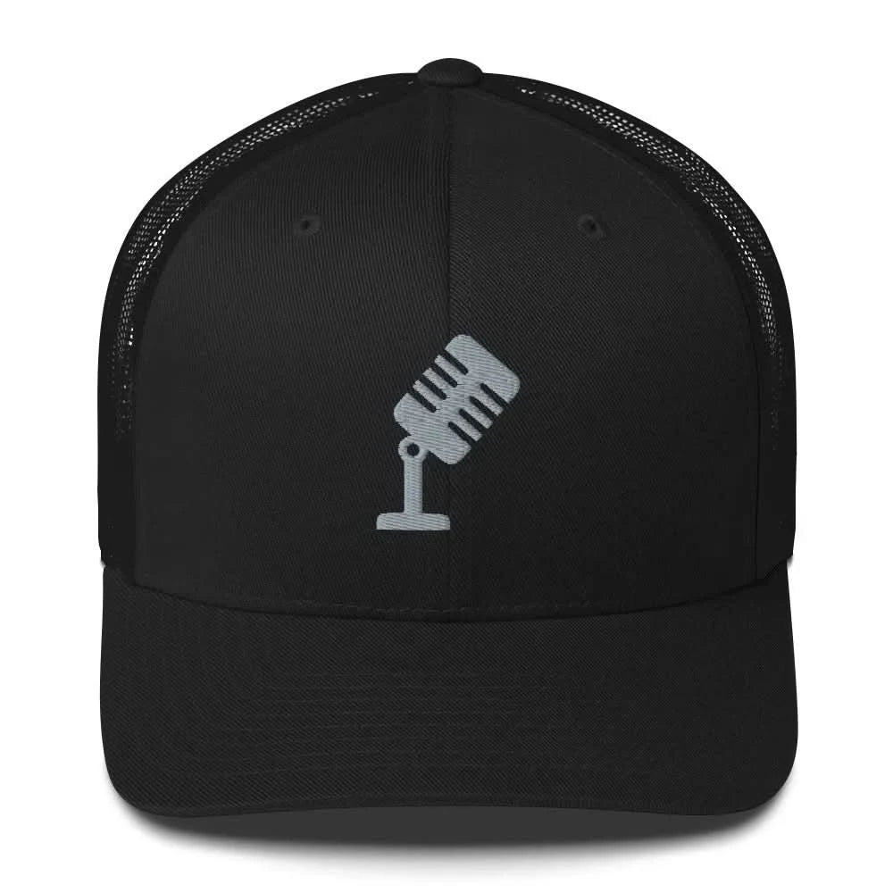 A black trucker hat with an embroidered silver vintage microphone by Rebel Girl Rampage 