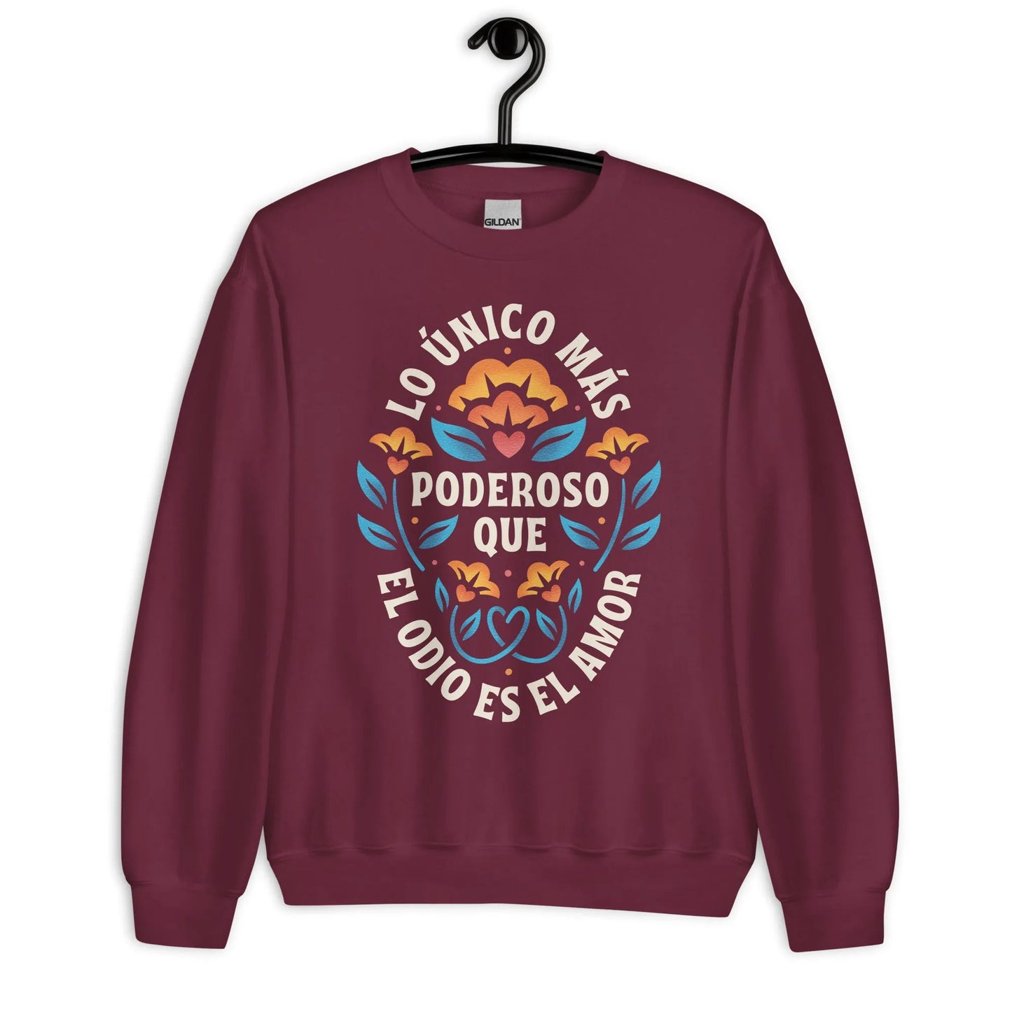 Burgundy unisex crewneck sweatshirt with a flower graphic and words that say, "Lo unicorn has poderoso que el odio es el amor." Love is more powerful than hate, bad bunny quote, super bowl halftime show 2026, Rebel Girl Rampage