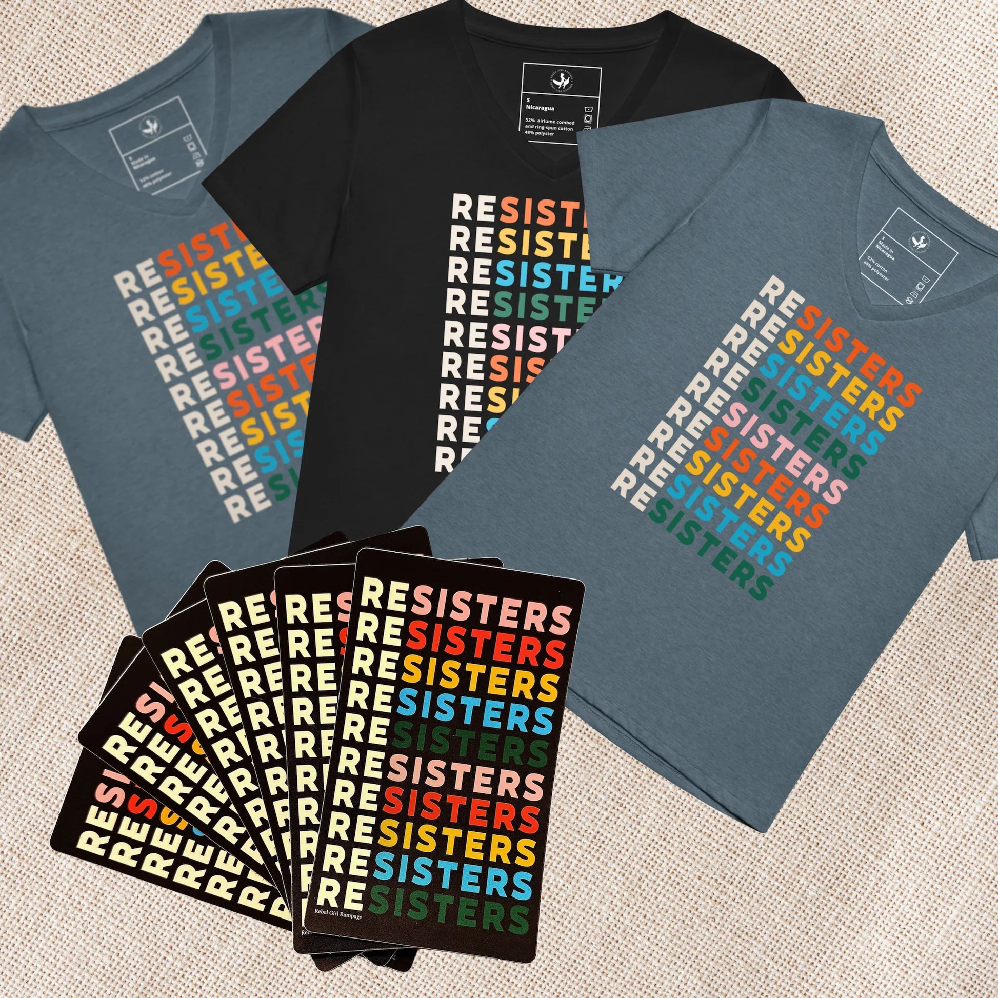 3 v-women’s v-neck T-shirts with ''RESISTERS' text in various colors on a textured surface with 6 stickers combined in a feminist holiday gift pack, Anne Lesniak, Rebel Girl Rampage 