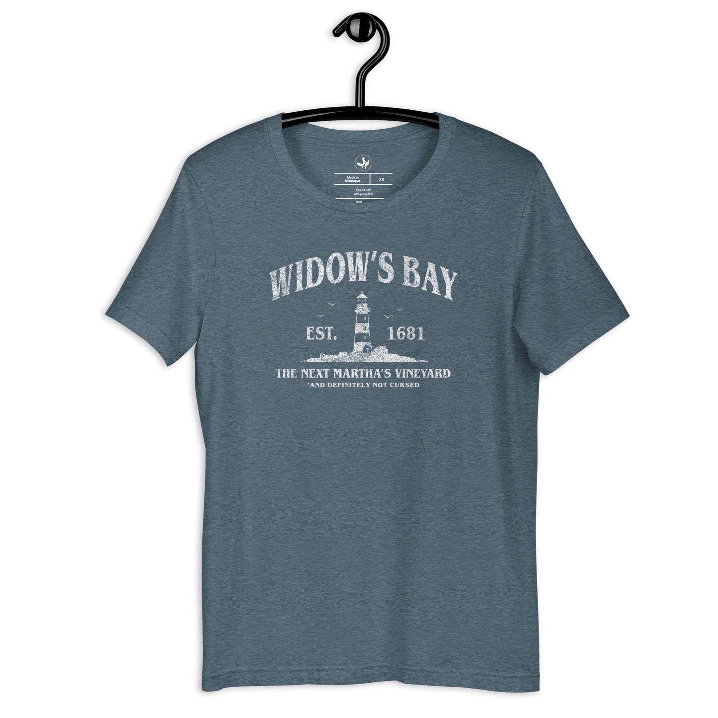 Widow’s Bay Heather Slate Unisex T-Shirt with a graphic of a lighthouse saying, “The Next Martha’s Vineyard. And definitely not cursed” Featuring a lighthouse at Rebel Girl Rampage 