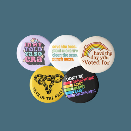 Progressive Pinback Buttons Set of Five Don’t Be Trash, Have The Day You Voted For, Year of the Snake Uterus, Punch Nazis, Rebel Girl Rampage