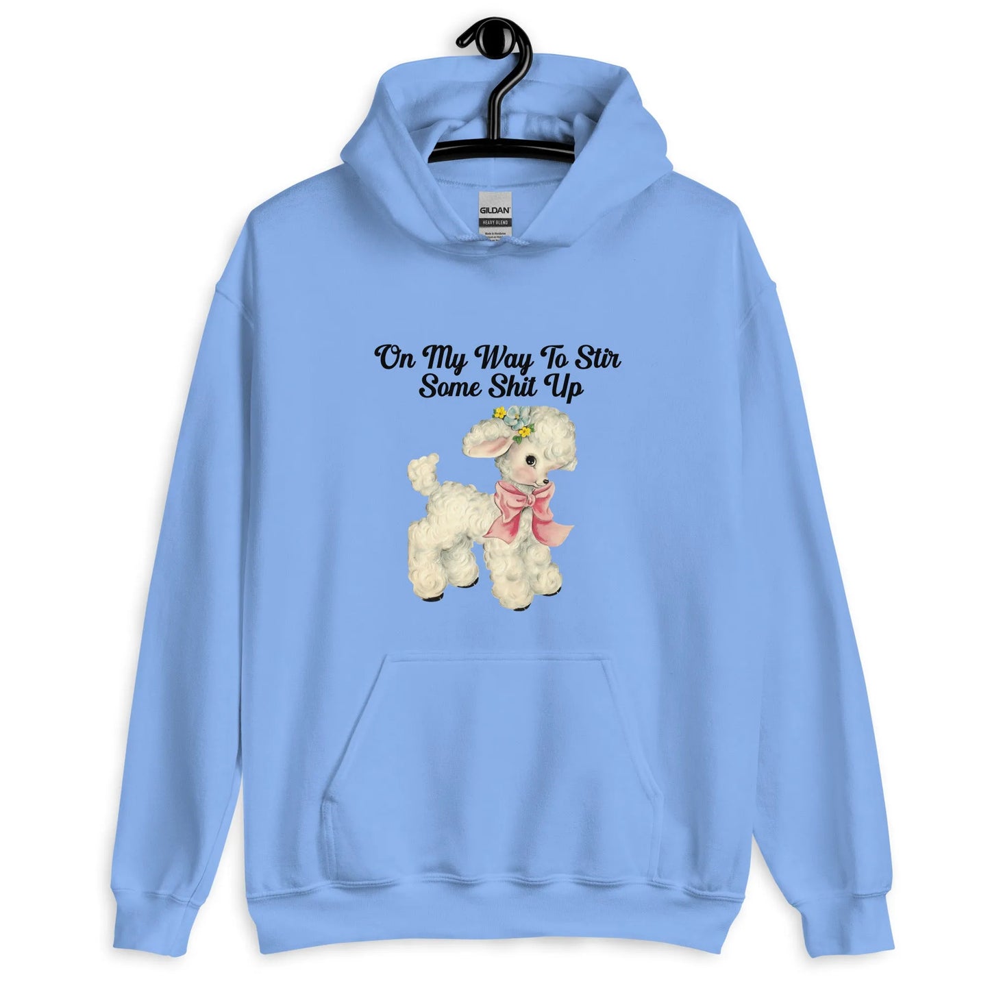 Light blue hoodie with a cute cartoon lamb with text that says, "on my way to stir some shit up." Cute & sassy graphic design, Rebel Girl Rampage 