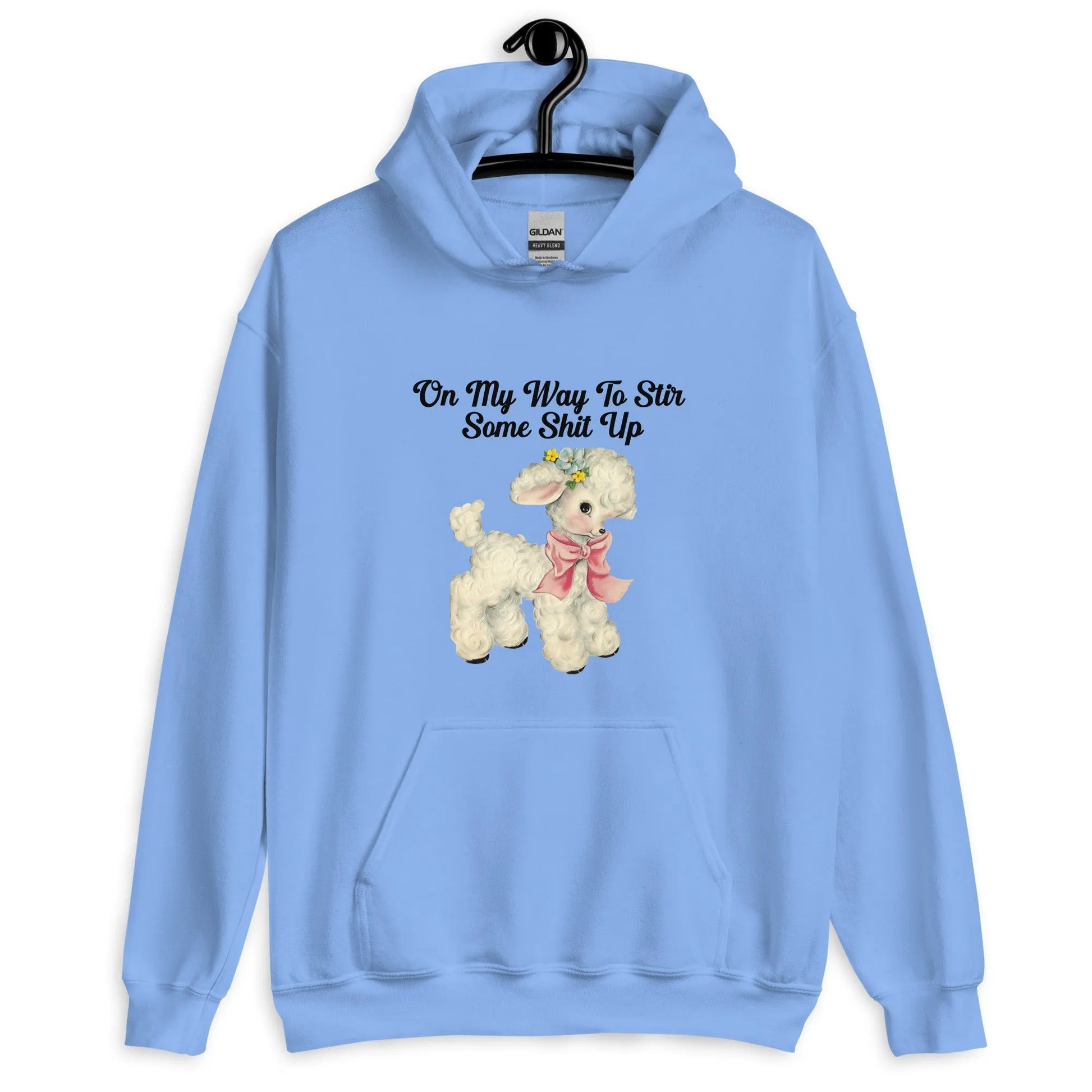Light blue hoodie with a cute cartoon lamb with text that says, "on my way to stir some shit up." Cute & sassy graphic design, Rebel Girl Rampage 