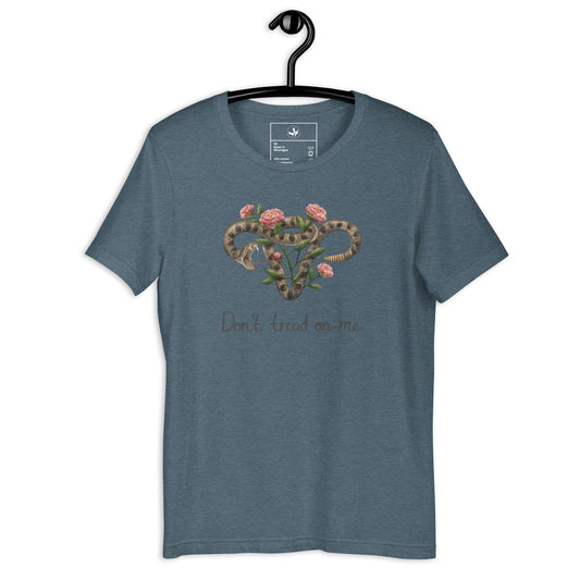 Don’t tread on me uterus with flowers heather slate t-shirt with a graphic of a rattlesnake coiled in the shape of a uterus with roses on a hanger against a white background