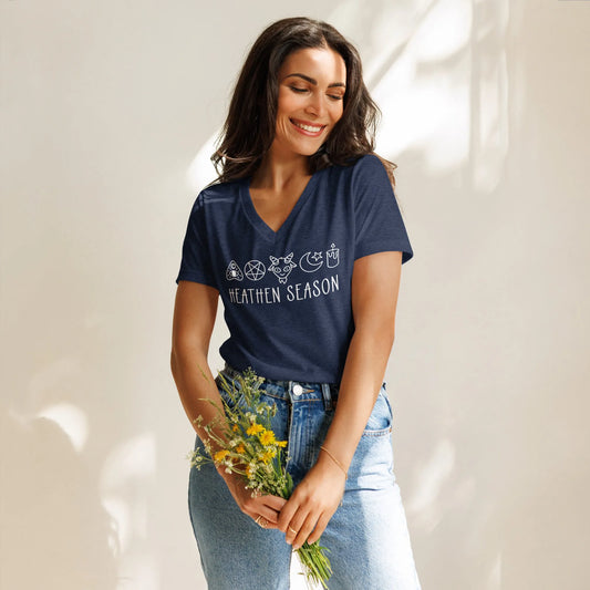 Heathen Season navy triblend women’s v neck t-shirt, adorable graphic of a pentagram, goat head , moon and stars, candle and ouija board symbols above the words “Heathen Season” ,  Anne Lesniak, Rebel Girl Ramage 